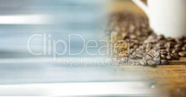 White coffee cup with beans and blurry blue transition