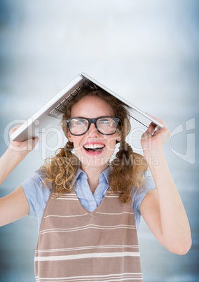 Nerd woman with laptop on head against blurry blue wood panel