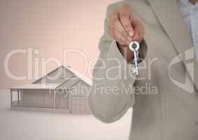 Woman Holding key with 3D house model in front of vignette