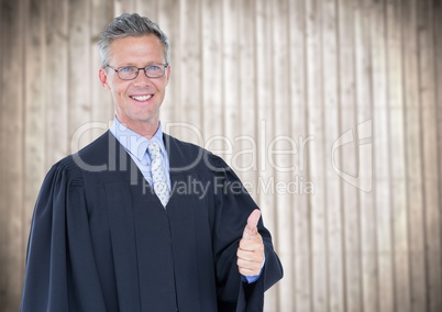 Male judge thumbs up against blurry wood panel