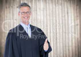Male judge thumbs up against blurry wood panel