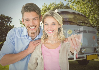 Couple Holding key in front of camper van