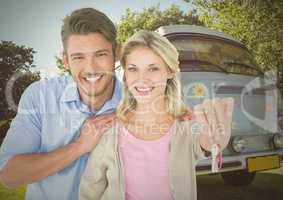 Couple Holding key in front of camper van