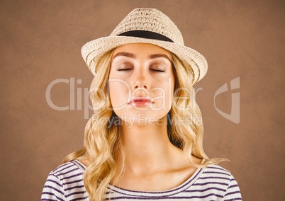 Close up of millennial woman eyes closed against brown grunge background