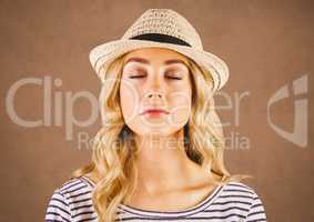 Close up of millennial woman eyes closed against brown grunge background