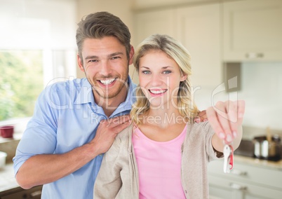 Couple Holding key in kitchen