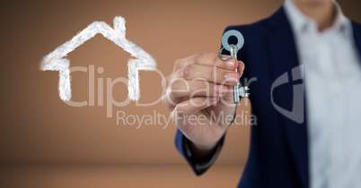 Hand Holding key with house drawing in front of vignette