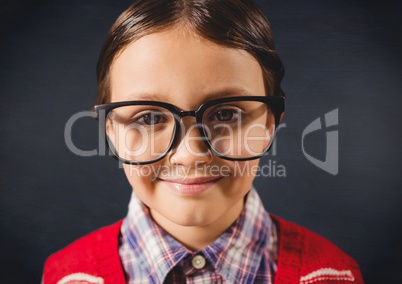 Close up of nerd boy against navy chalkboard