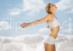 Woman soaking up sun against blurry sky