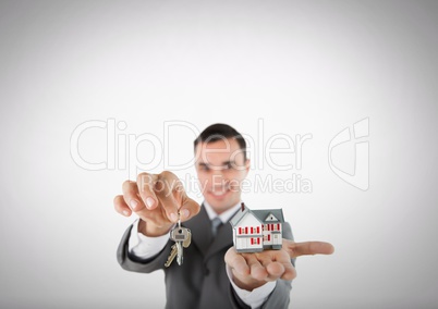 Man Holding key and house in front of vignette