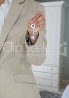 Hand holding key in home