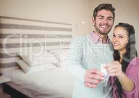 Couple Holding key in bedroom
