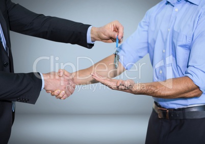 Men holding keys handshake in front of vignette