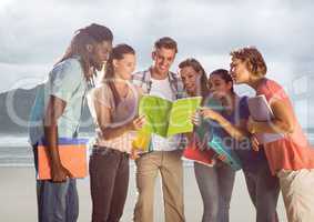 Group of friends at beach with books