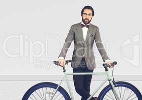 Millennial man in suit with bike against white wall