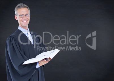 Male judge with open book against navy chalkboard