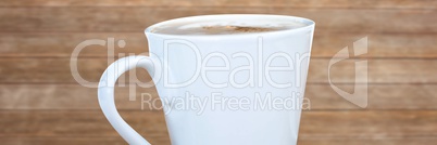 White coffee cup against blurry wood panel