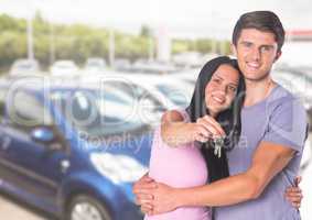 Couple  Holding key in front of cars