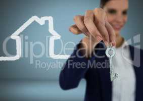 Woman Holding key with house icon in front of vignette