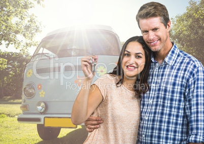 Couple holding keys in front of Camper van