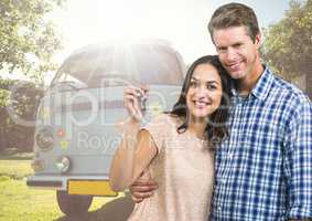 Couple holding keys in front of Camper van