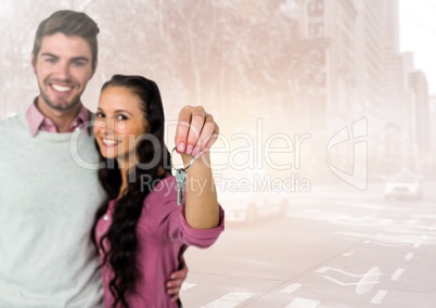 Couple  Holding key in front of street road
