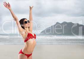 Woman in red bikini against blurry beach
