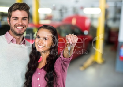 Couple  Holding key in front of car