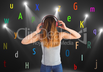 young woman listening music with colour letters around. Black back