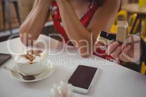 Cropped hand of man giving ring to girlfriend