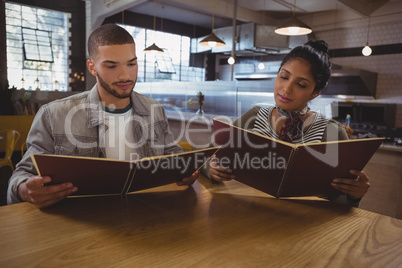 Friends reading menu at table