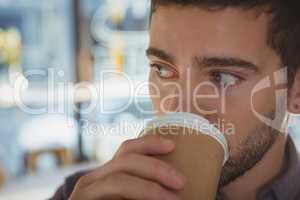 Close-up of young man drinking coffee