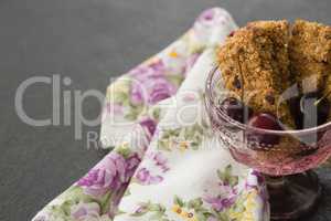 Granola bar and berry fruits on black background