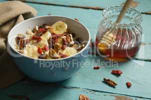 Fruit cereal and honey on a wooden table