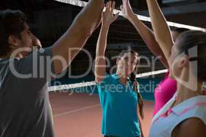 Volleyball players giving high-five to each other