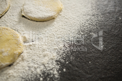 Cropped image of flour on unbaked cookies