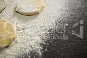 Cropped image of flour on unbaked cookies