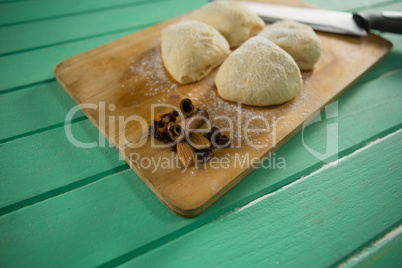 Close up of raw cookies by knife on cutting board