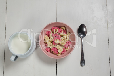 Bowl of honeycomb cereal and milk on wooden table