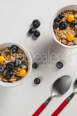 Blueberry, golden berry and oatmeal in bowl