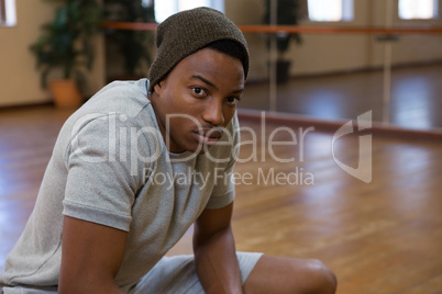 Portrait of dancer crouching in studio