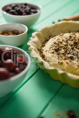 Close up of tart with olives and alomds