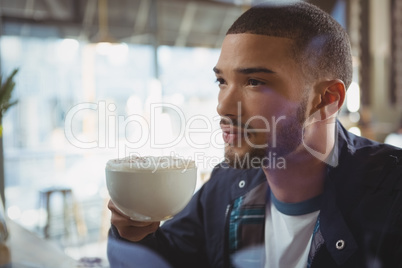 Thoughtful man having coffee in cafe