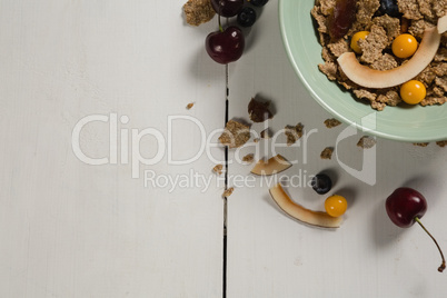 Bowl of wheat flakes with blueberry and golden berry