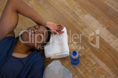 High angle view of male dancer sleeping on floor