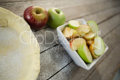 Tilt image of apples and pastry dough in container