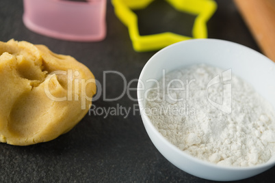 High angle view of dough and flour in bowl