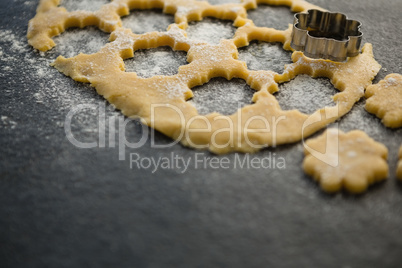 High angle view of flower shape pastry cutter on dough