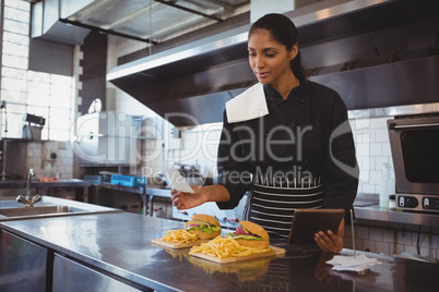 Waitress with tablet and food in cafe