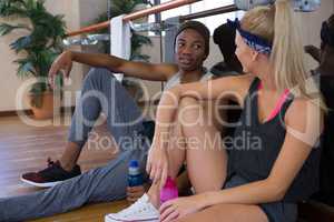 Tired dancers sitting at studio